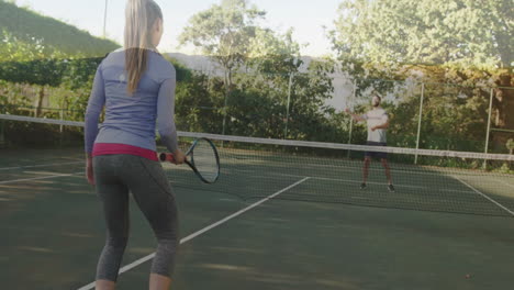woman holding racket and man swinging forehand on court, showing sports data graph overlays