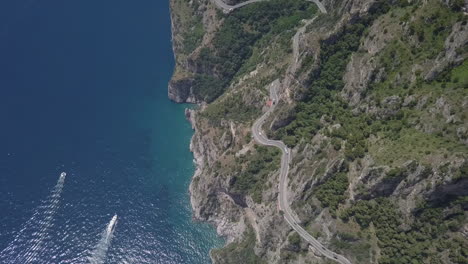 bird's eye aerial of twisty scenic mountain coastal highway, italy