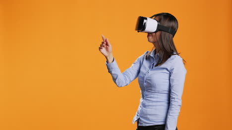 asian woman operates virtual reality headset on camera