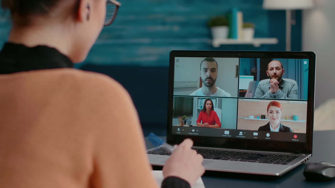 Female student attending remote videoconference on webcam