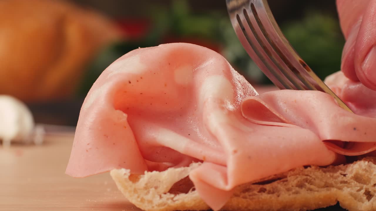 Preparing a sandwich with salami and ciabatta bread