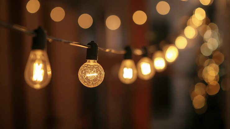 Showing filament bulb glowing at patio, subtle flicker shifting brightness while creating warm glow