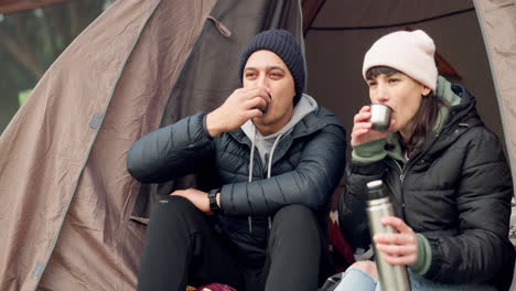 couple, coffee and relax in tent while camping