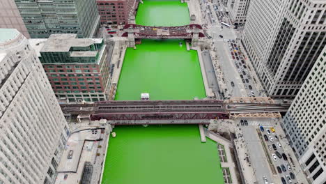 aerial view following a tourist ferry on the chicago river on st