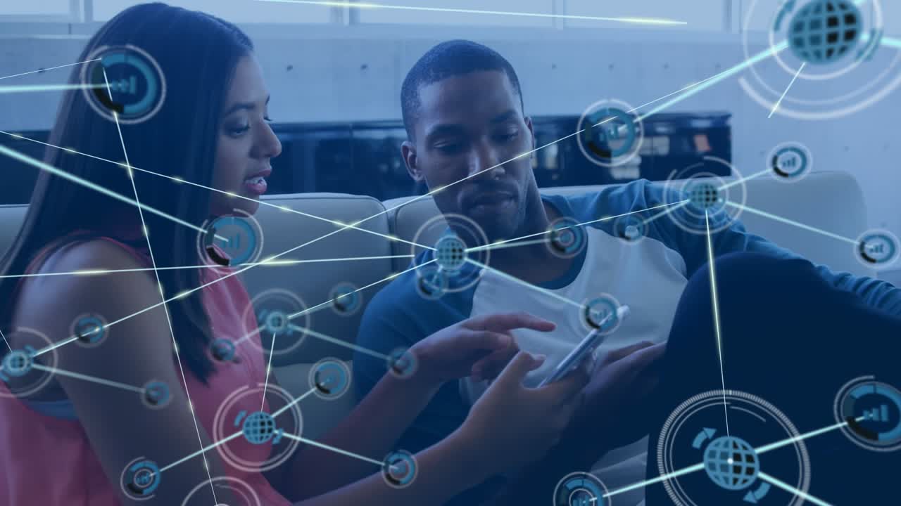 Animation of network of digital icons over diverse male and female colleagues discussing at office