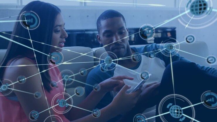 Animation of network of digital icons over diverse male and female colleagues discussing at office