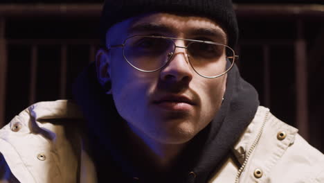close-up portrait of a stylish young man at night