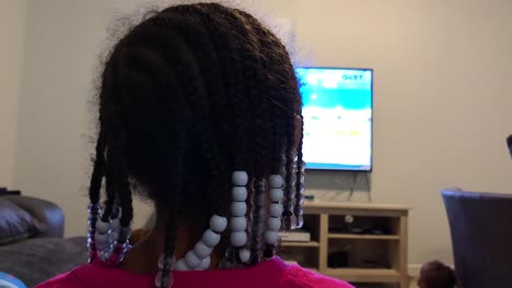 kid playing video game at home