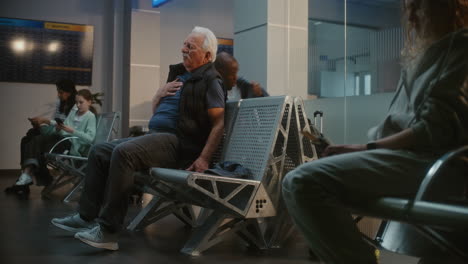man having medical emergency at airport
