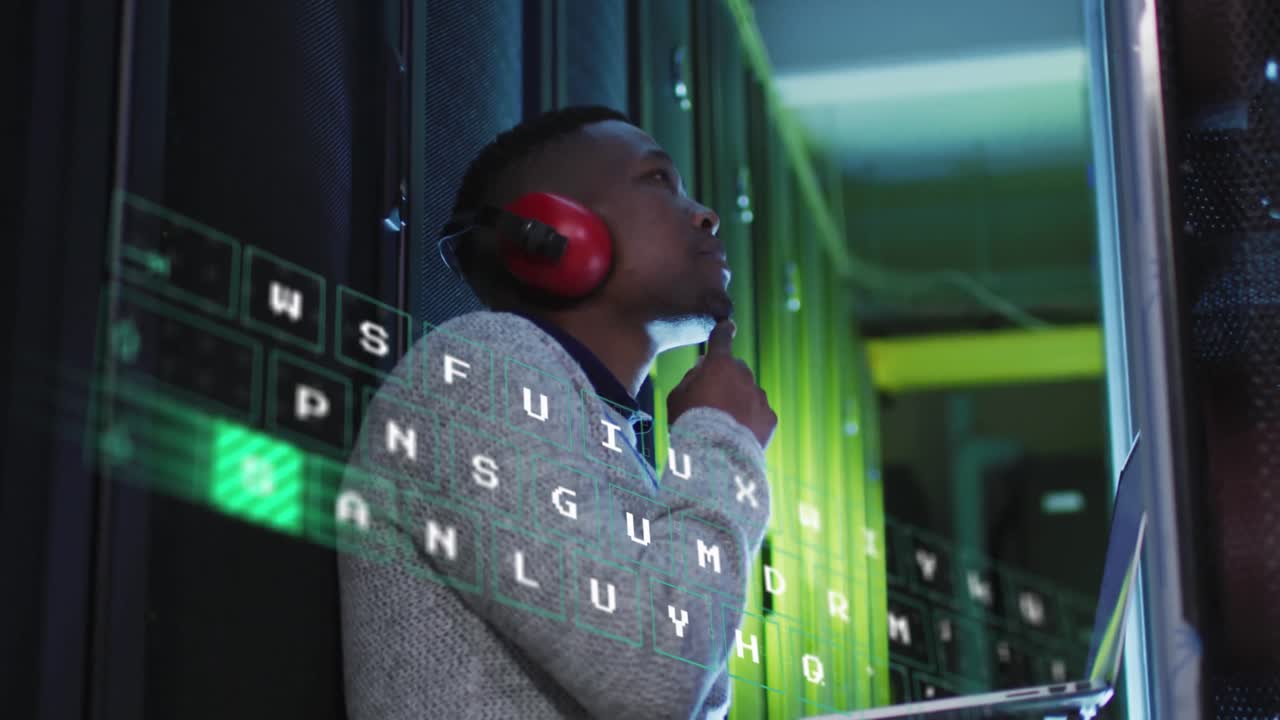 Animation of over changing letters over african american man working in server room