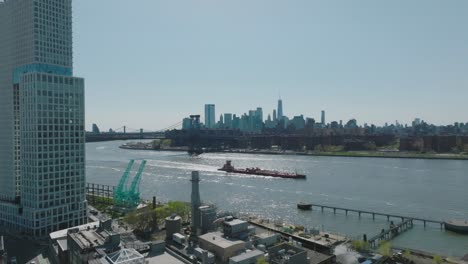 ship sailing at east river with downtown brooklyn skylines in the background, new york city, usa