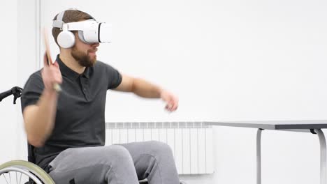 man in wheelchair admiring art in virtual reality using headset in gallery tiltup low angle shot of african american man in wheelchair holding leaflet and admiring art in virtual reality using headset at art exhibition in gallery
