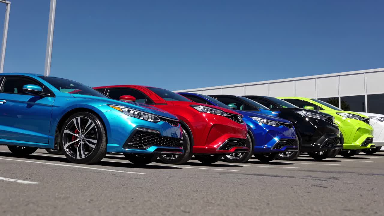 Low-angle video shot of a vibrant lineup of sports cars in various colors, showcasing sleek design