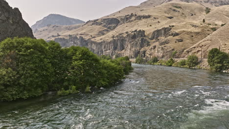 deschutes river oregon aerial v85 cinematic drone flyover deschutes river rapids along the bend capturing spectacular canyon landscape with rocky cliff wall - shot with mavic 3 cine - august 2022