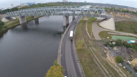 Flying-over-railway-bridge-and-car-traffic