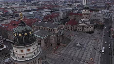 Forwards-fly-above-large-square-with-historical-buildings.-German-and-French-churches-and-concert-hall-between-town-development.-Berlin,-Germany