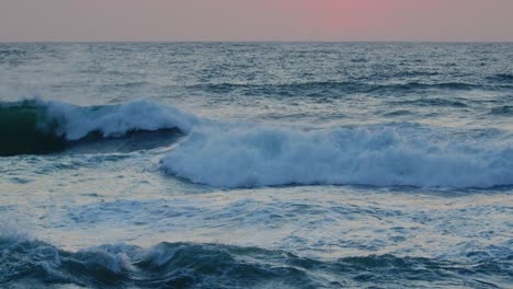 beautiful red sky over the indian ocean, durban kwazulu-natal south africa. summer sunset seascape with breaking waves.