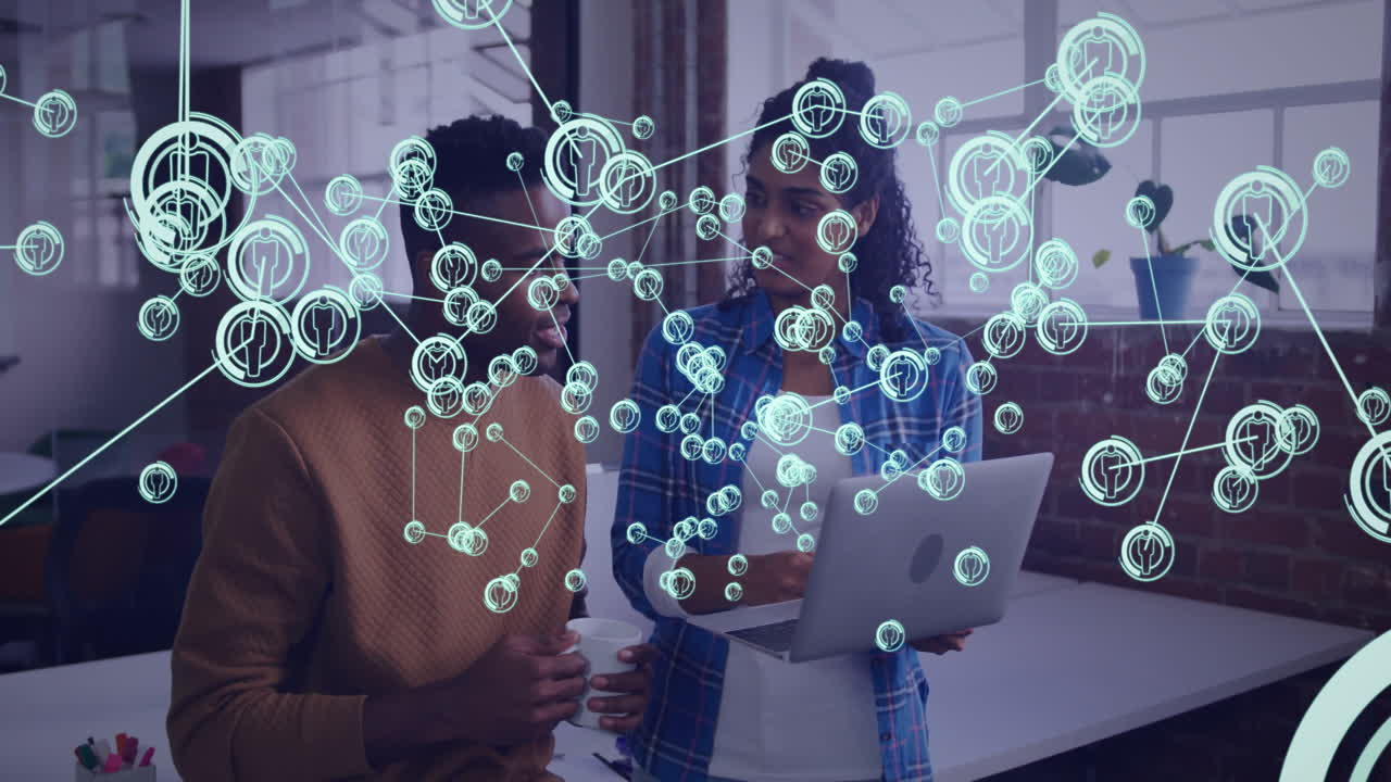 Two people discussing with laptop, network connections animation overlaying scene