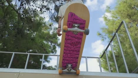 young boy on skateboard getting ready to slide on the ramp