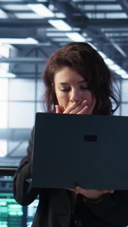 vertical video server room worker under pressure to secure sensitive data after threat alert