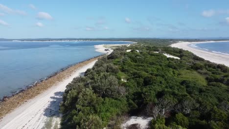 aerial view of a sandy spit extending into the coastal waters, capturing the scenic beauty of ilha da armona, portugal, with its pristine beach and surrounding natural landscape