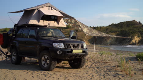 a camping car parked beside a beach