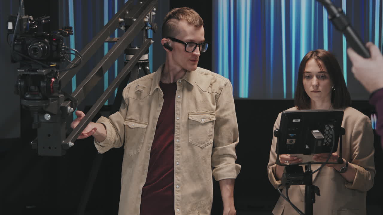 Cameraman With Team Shooting Video In Studio Using Crane