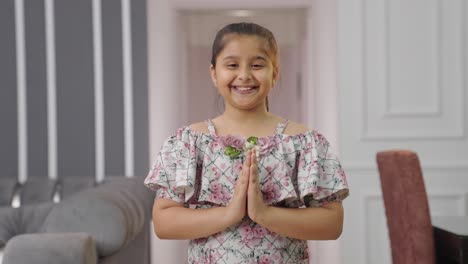 indian kid girl doing namaste and greeting