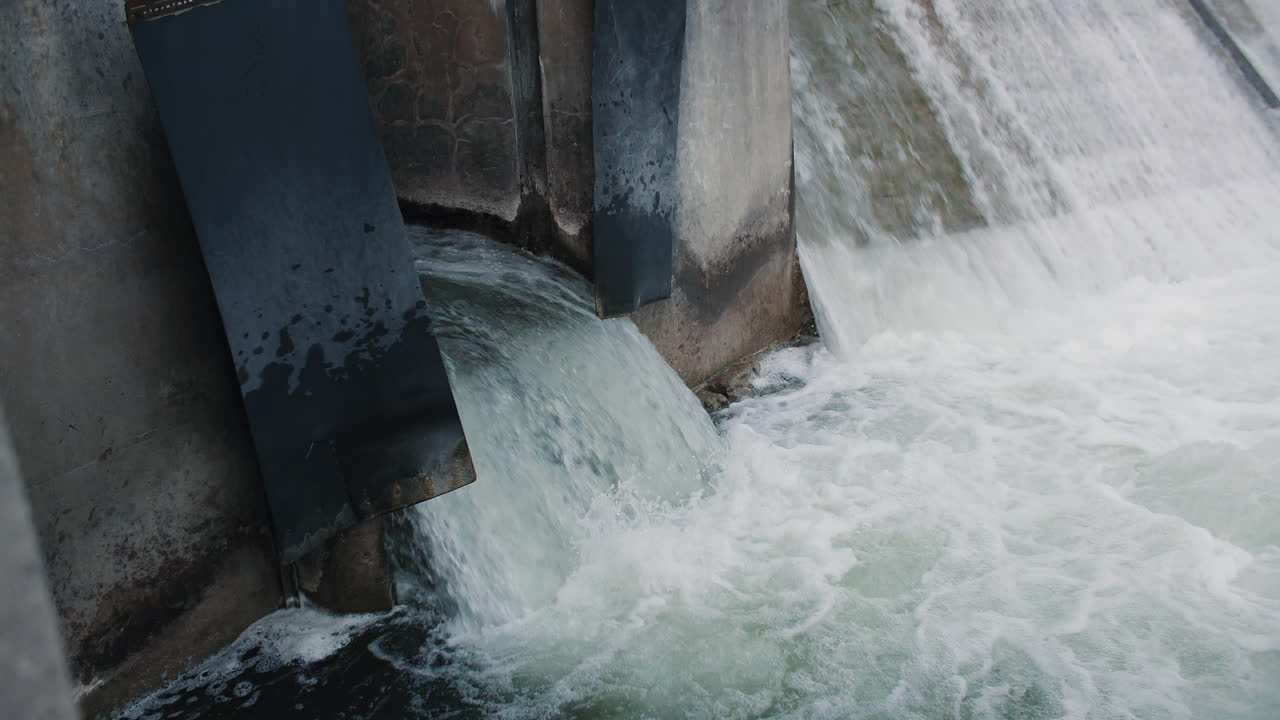 Rushing Water Flowing out of Dam Drainage Overflow Flood Gate