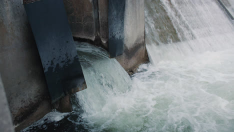 rushing water flowing out of dam drainage overflow flood gate