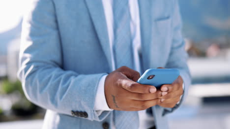 Text-message,-phone-and-hands-of-black-man-in-city