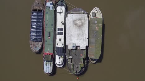 top down aerial rising view of boats moored on the river medway, kent, uk