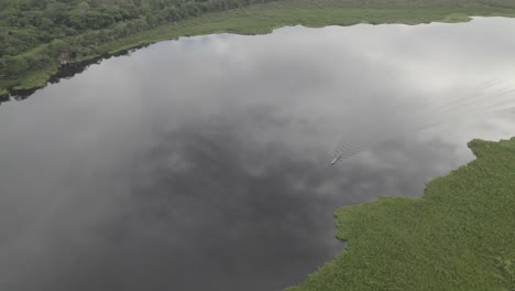 sailing on pristine water of laguna negra in tropical forest of colombia