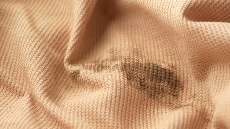 close up of a brown waffle fabric with a stain