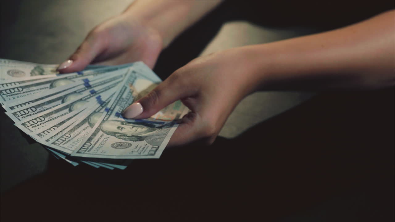 mujer sosteniendo dólares