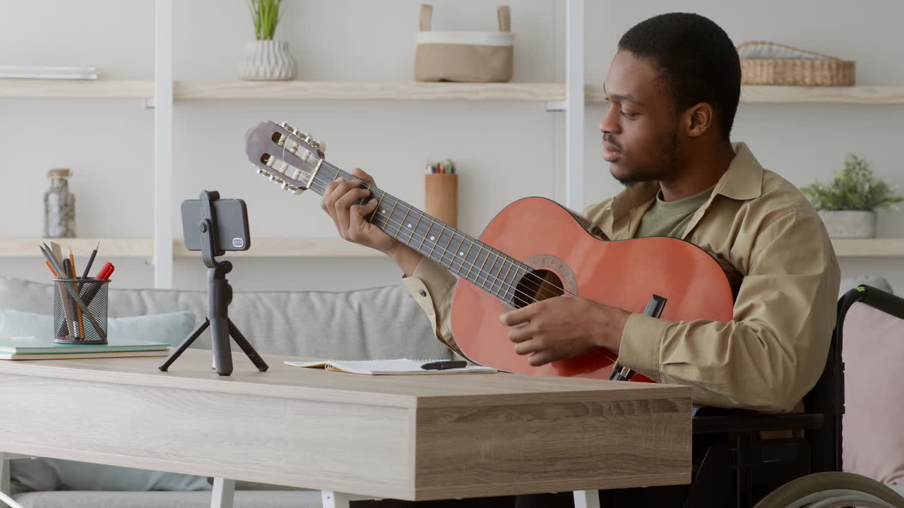 Man in Wheelchair Learning Guitar Online