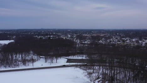 an aerial view from a drone, over a frozen lake during sunrise on a cloudy morning