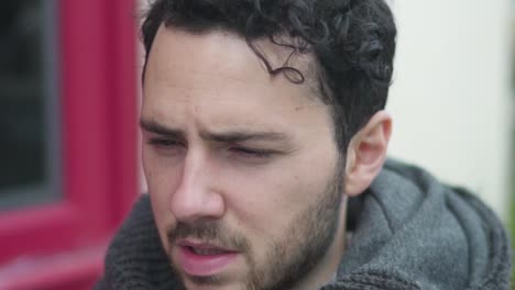 depressed man sitting in a cafe, feeling upset, worried, sighs and thinking about bad things