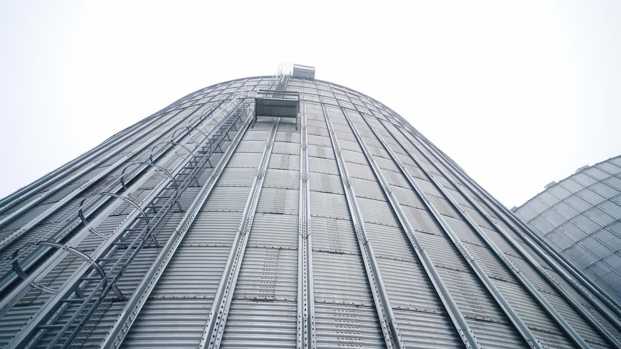 Big storage elevator construction. Steel hude agricultural storage for farming.