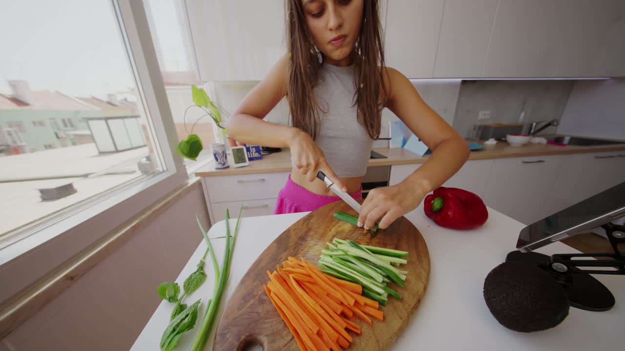 Donna che taglia verdure per un pasto sano in una cucina moderna
