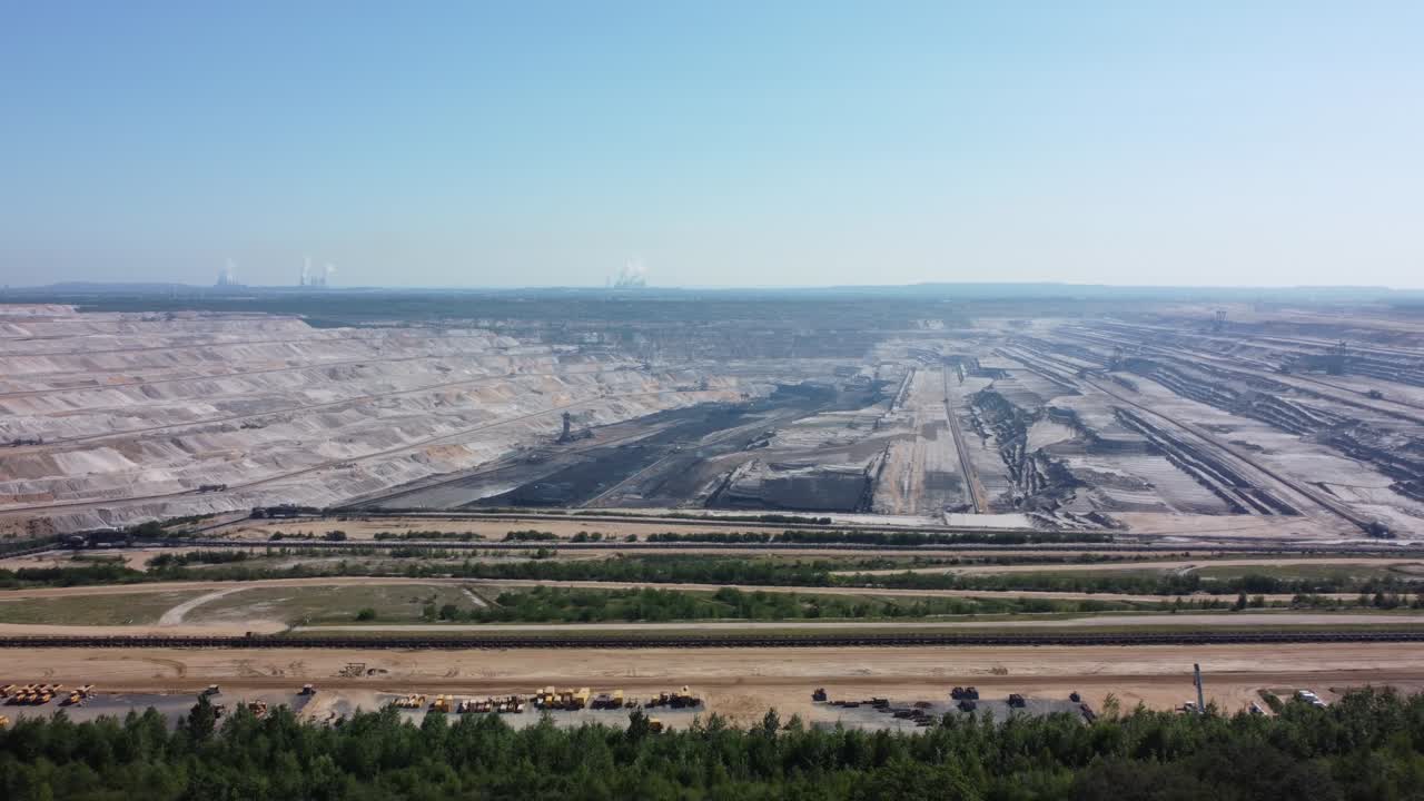 Hambach opencast lignite mine in the Rhenish lignite mining area near Düren, Aerial flying from the forest