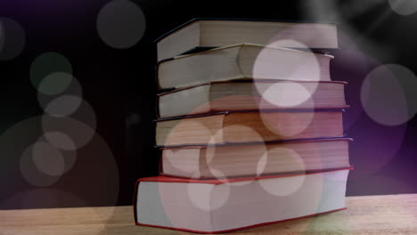 animación de puntos de luz sobre libros sobre fondo negro