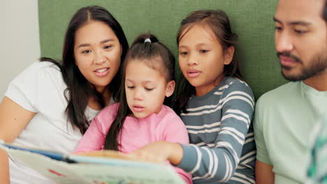 mother, father and children reading a book