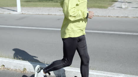 active senior jogger with hearing aid device running outside