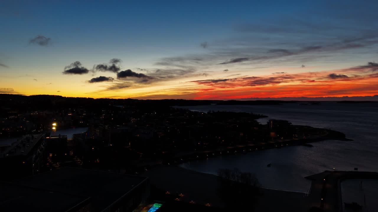 American town on coast of ocean during golden sunset. Lighting Cityscape with port in America. Aerial wide shot.