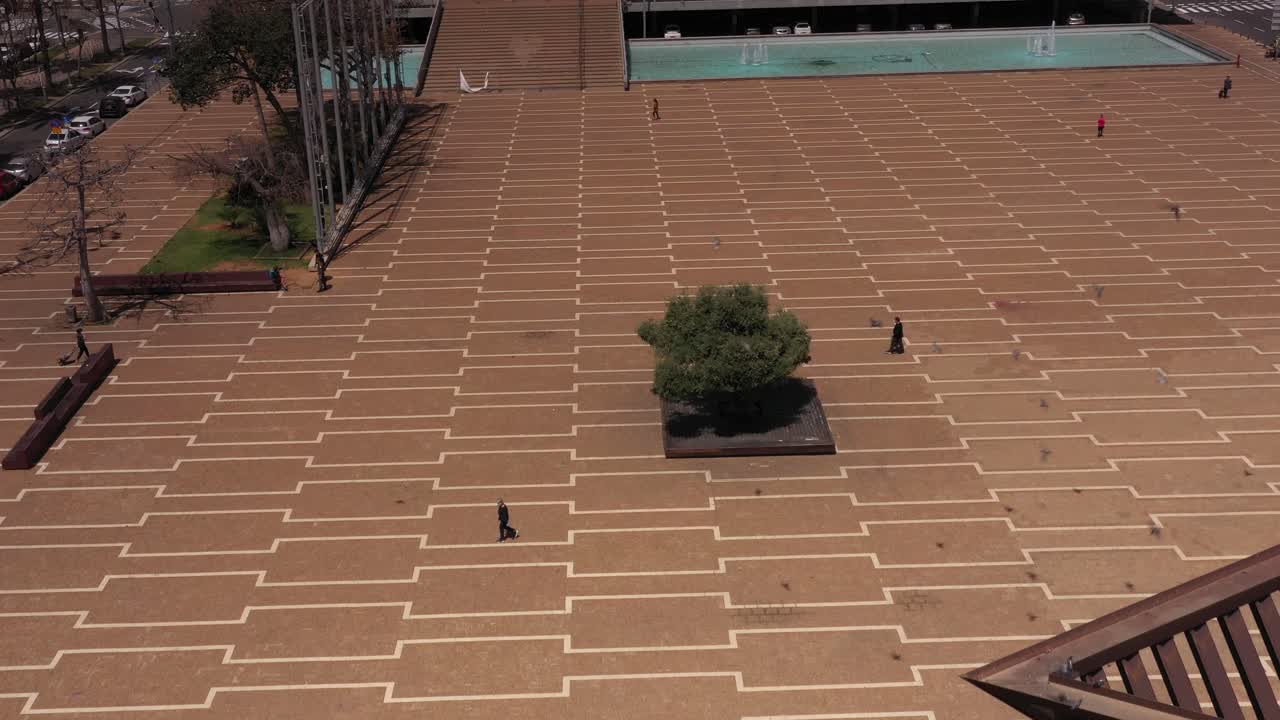 Aerial View of a City Square with Fountains and People