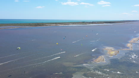 large aerial view over men kite boarding and windsurfing on the etang de thau