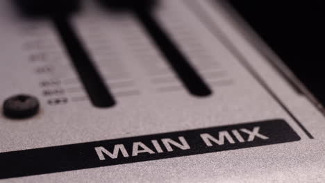 Turning-Volume-Down-on-Master-Main-Mix-of-Mixing-Console,-Macro-Close-Up