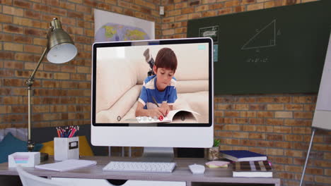 caucasian schoolboy learning displayed on computer screen during video call