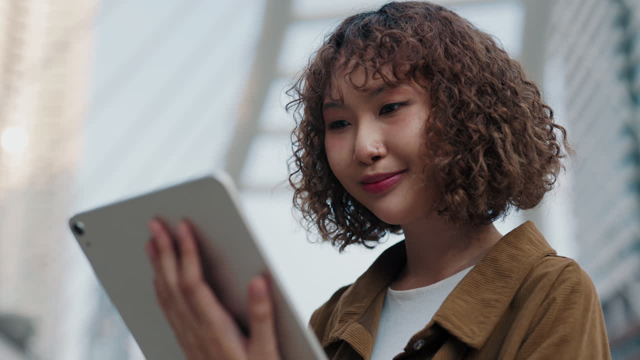 Young Woman Using Tablet in City